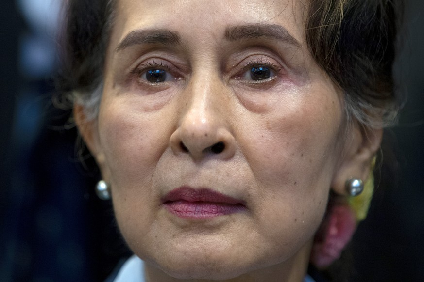 FILE - Myanmar&#039;s leader Aung San Suu Kyi waits to address judges of the International Court of Justice on the second day of three days of hearings in The Hague, Netherlands on Dec. 11, 2019. (AP  ...