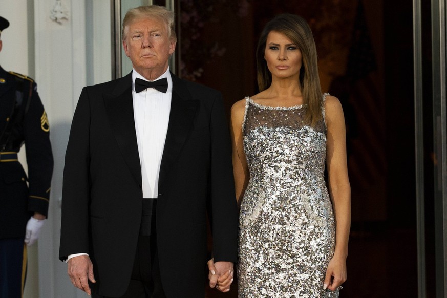 United States President Donald J. Trump and first lady of the United States Melania Trump emerge from the White House as the await the arrival of French President Emmanuel Macron and first lady of Fra ...