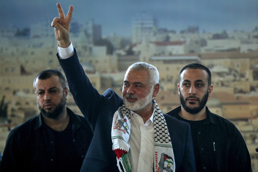 26.06.2022, Libanon, Sidon: Ismail Hanija (M), Chef der Hamas, zeigt das Victory-Zeichen w