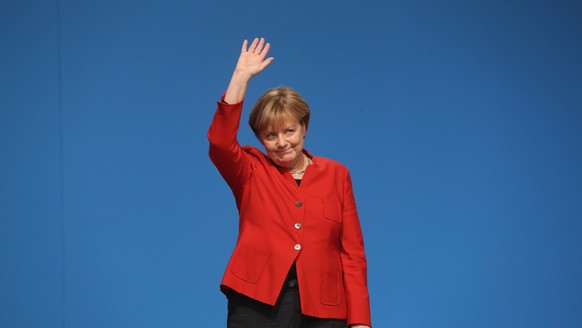 ESSEN, GERMANY - DECEMBER 06: German Chancellor and Chairwoman of the German Christian Democrats (CDU) Angela Merkel waves to applauding delegates after she gave her central speech at the 29th federal ...