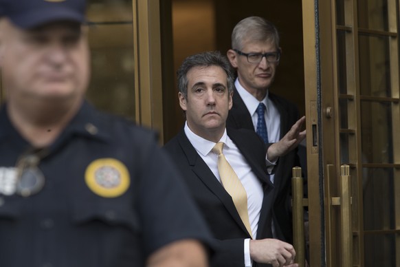 Michael Cohen, center, leaves Federal court, Tuesday, Aug. 21, 2018, in New York. Cohen, has pleaded guilty to charges including campaign finance fraud stemming from hush money payments to porn actres ...