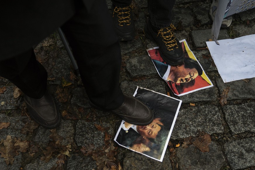 Protesters step over pictures of Chinese President Xi Jinping during a protest against China's brutal crackdown on ethnic group Uyghurs, in front of the Chinese consulate in Istanbul, Turkey, Wednesda ...