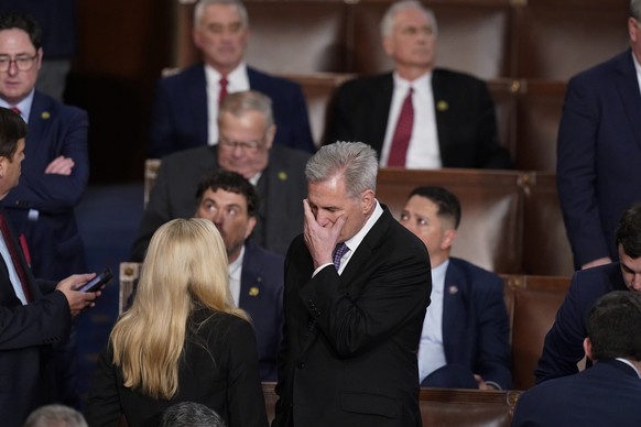 Rep. Kevin McCarthy, R-Calif., talks with Rep. Marjorie Taylor Greene, R-Ga., at the beginning of an evening session after six failed votes to elect a speaker and convene the 118th Congress in Washing ...