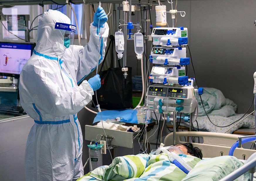 200124 -- WUHAN, Jan. 24, 2020 -- A medical worker checks drip of a patient in the ICU intensive care unit of Zhongnan Hospital of Wuhan University in Wuhan, central China s Hubei Province, Jan. 24, 2 ...