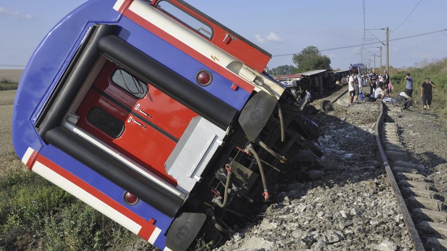 An overturned train car is seen near a village at Tekirdag province, Turkey Sunday, July 8, 2018. At least 10 people were killed and more than 70 injured Sunday when multiple cars of a train derailed  ...