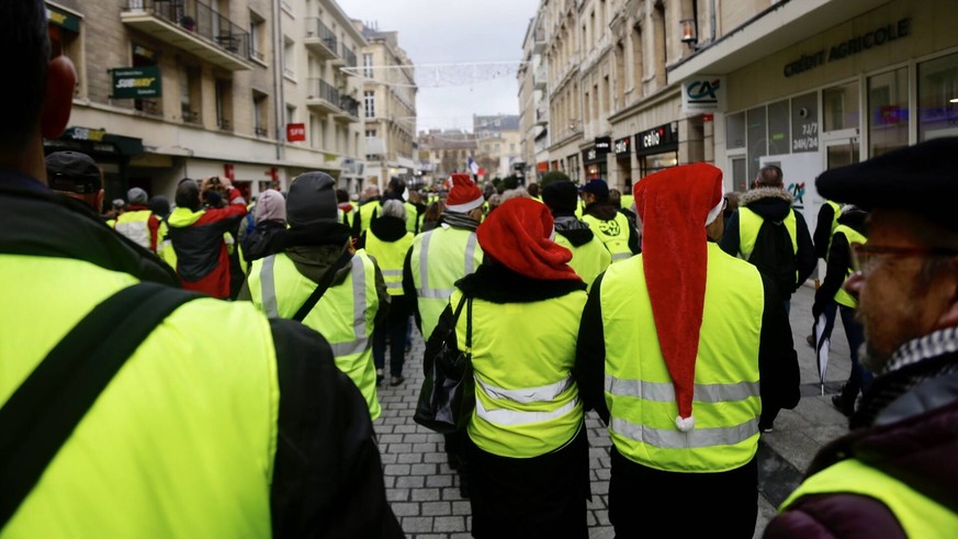 December 22, 2018 - Caen, France - Protesters wearing Yellow Vests (Gilets jaunes) gather in Caen, Normandie, France, on December 22, 2018. The Yellow Vests movement in France originally started as a  ...