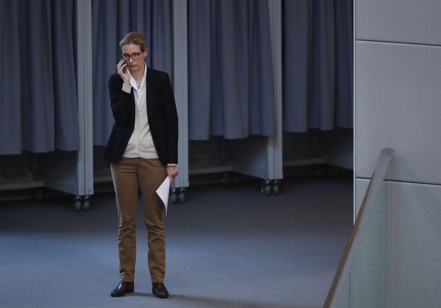 BERLIN, GERMANY - FEBRUARY 01: Alice Weidel of the right-wing Alternative for Germany (AfD) political party speaks on a mobile phone as she attends debates at the Bundestag over a proposal concerning  ...