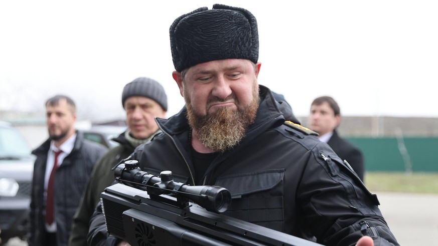 RUSSIA, CHECHEN REPUBLIC - DECEMBER 25, 2022: Ramzan Kadyrov front, head of the Chechen Republic, examines weapons during a meeting with Kremlin First Deputy Chief of Staff Sergei Kiriyenko and Russia ...