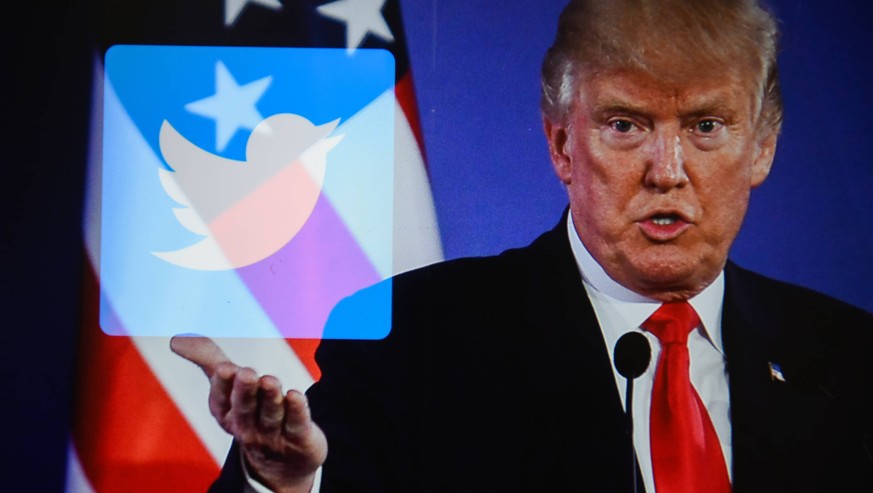 July 26, 2018 - Krakow, Poland - A double exposure image shows the President of United States of America, Donald Trump with social media logo Twitter in this photo illustration. Krakow Poland PUBLICAT ...