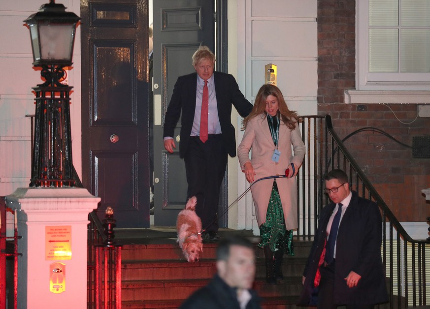 General Election 2019. Prime Minister Boris Johnson leaving Conservative Party Headquarters, with with partner Carrie Symonds and dog Dilyn in central London as his party romped to victory in the 2019 ...