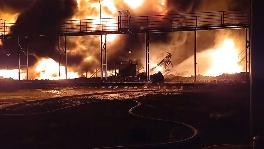 VIDEO AVAILABLE: CONTACTiNFoCOVERMG.COM These images and video show State Emergency Service of Ukraine workers in the Zhytomyr region tackling a fire at an oil depot following airstrikes by Russian fo ...