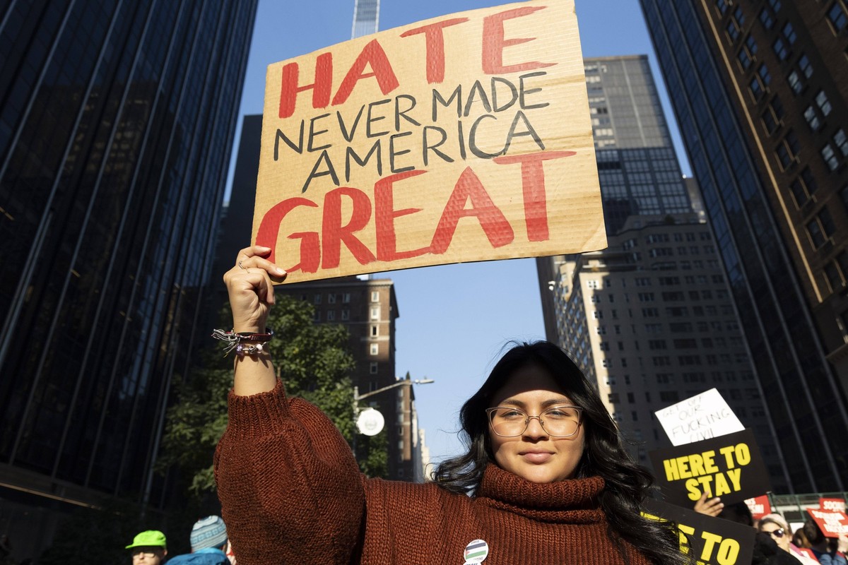 November 9, 2024, New York, New York, USA: A person holds a sign that reads HATE NEVER MADE AMERICA GREAT. Anti-Trump protesters hold banners and signs as they march through midtown Manhattan. A coali ...