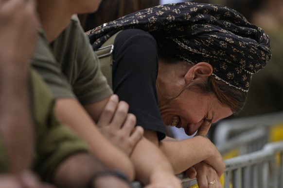 A woman cries during the funeral of Israeli Col. Roi Levy at the Mount Herzl cemetery in Jerusalem on Monday, Oct. 9, 2023. Col. Roi Levy was killed after Hamas militants stormed from the blockaded Ga ...