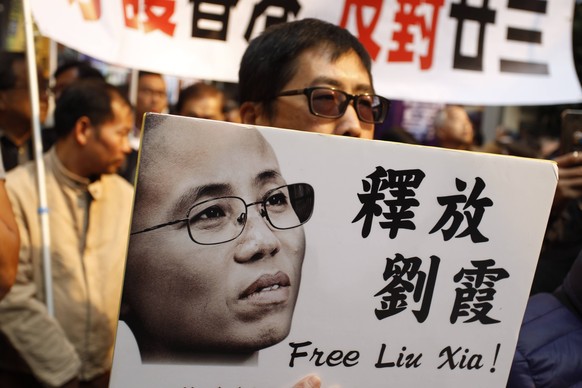 January 1, 2018 - Hong Kong, CHINA - Man display an image placard of LIU XIA, a widow of the late LIU XIAO BO, Nobel Peace Prize Laureate demanding for her immediate release on the annual New Years Da ...