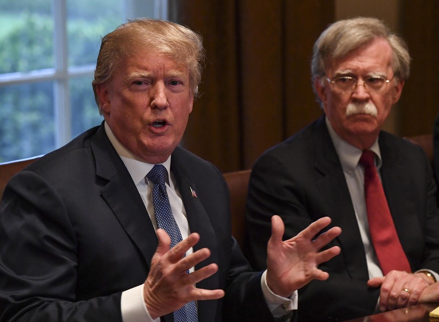 WASHINGTON, DC - APRIL 9: President Donald Trump, left, flanked by national security advisor John Bolton, right, speaks to the media as he meets with senior military leadership in the Cabinet Room of  ...