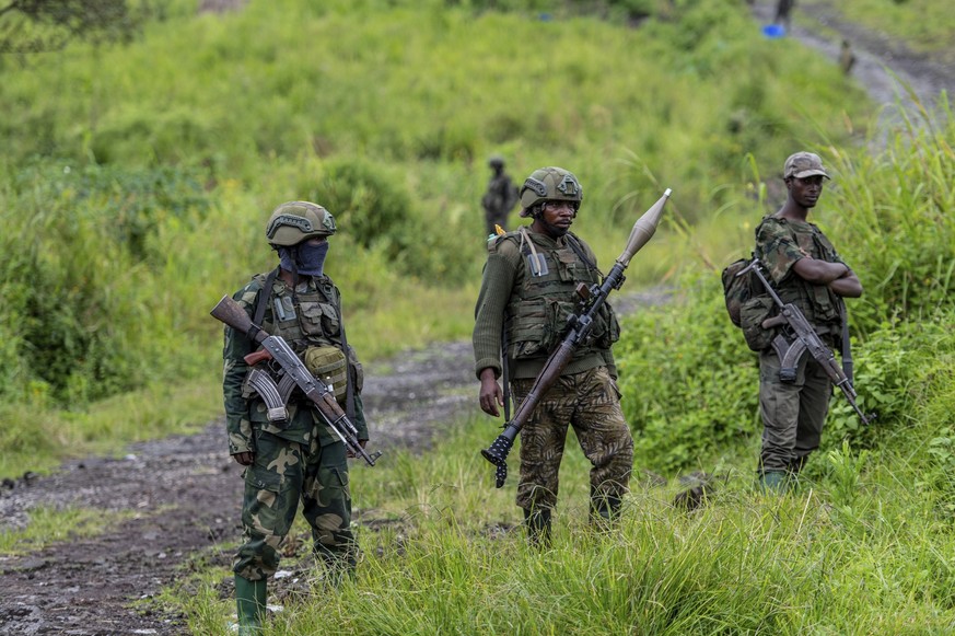 FILE - M23 rebels stand with theirs weapons in Kibumba, in the eastern of Democratic Republic of Congo, Dec. 23, 2022. Aid organisations fear a new humanitarian crisis in the restive eastern Congo reg ...