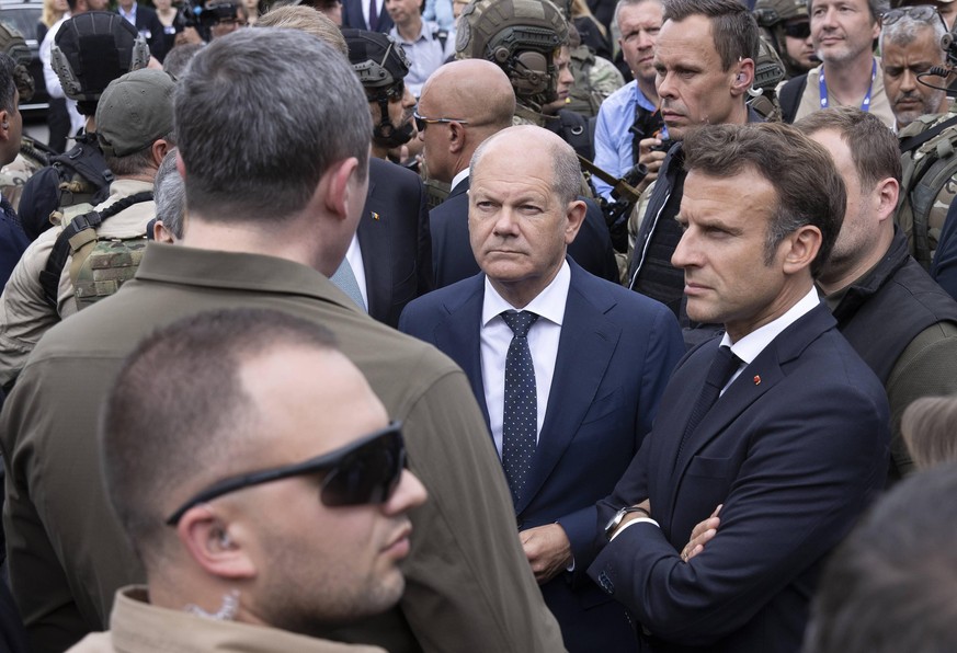 German Chancellor Olaf Scholz C and French President Emmanuel Macron R visit a destroyed neighborhood in Irpin, Ukraine, 16 June 2022. The European leaders Emmanuel Macron, Mario Draghi and Olaf Schol ...