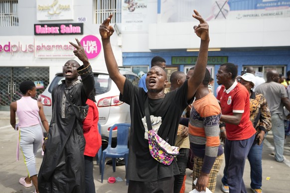 People celebrates after electoral officials announce a result from of the polling station in Lagos, Nigeria, Saturday, March 18, 2023. Millions of Nigerians are headed back to the polls Saturday as Af ...