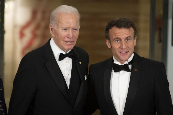 United States President Joe Biden L welcomes President Emmanuel Macron of France to a State Dinner, in their honor, on the North Portico of the White House, in Washington, DC on Thursday, December 1,  ...