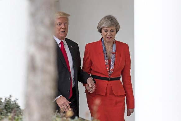WASHINGTON, DC - JANUARY 27: British Prime Minister Theresa May and U.S. President Donald Trump walk along The Colonnade of the West Wing at The White House on January 27, 2017 in Washington, DC. Brit ...