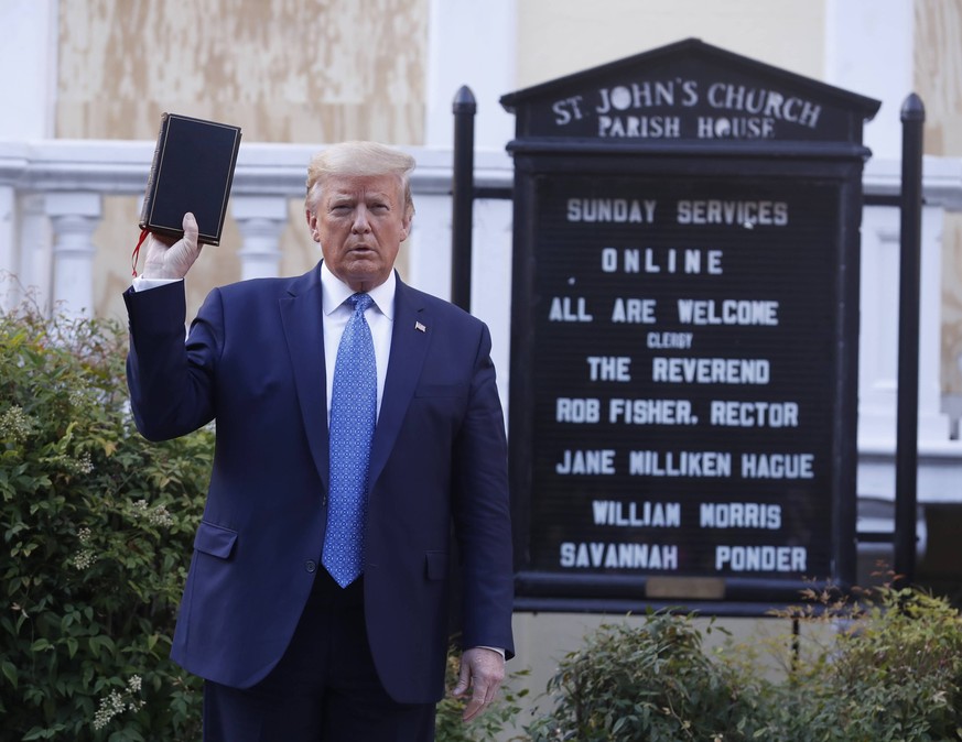 President Donald J. Trump poses with a bible outside St. John s Episcopal Church after delivering remarks in the Rose Garden at the White House in Washington, DC, on Monday, June 1, 2020. Trump addres ...