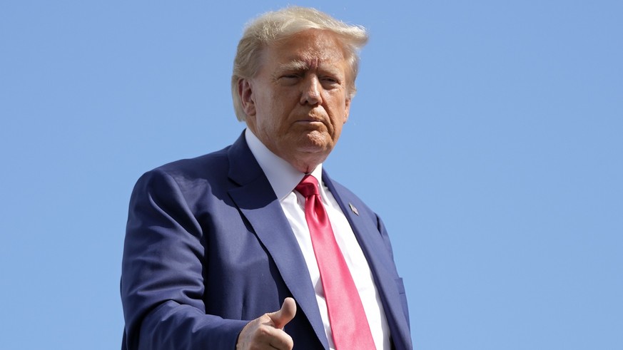 Former President Donald Trump gives a thumbs up before boarding his personal plane at Miami International Airport, Tuesday, June 13, 2023, in Miami. Trump appeared in federal court Tuesday on dozens o ...