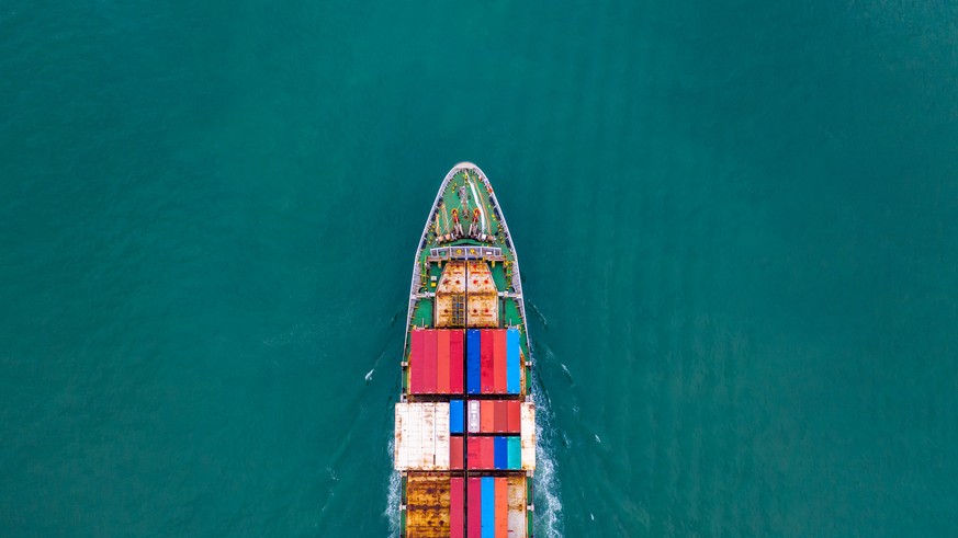 Aerial view container ship carrying container for import and export, business logistic and freight transportation by ship in open sea.