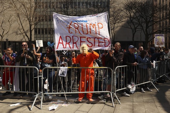 Demonstrators gather outside New York criminal court, Tuesday, April 4, 2023, in New York. Former President Donald Trump is set to appear in a New York City courtroom on charges related to falsifying  ...
