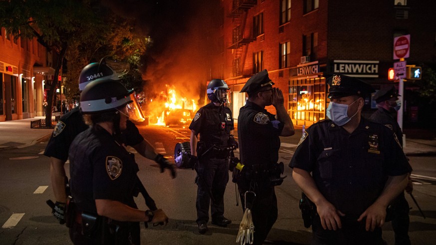 200530 Police in front of a police car that has been set one fire during a protest over the death of George Floyd, on May 30, 2020 close to Union Square in the Manhattan borough of New York, NY, USA. ...