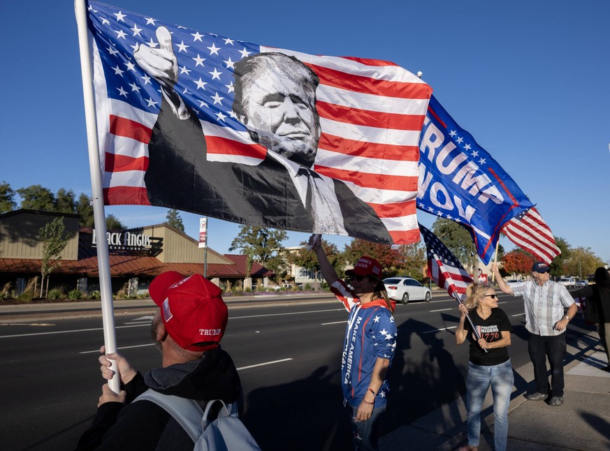 November 6, 2024, Sacramento, Ca, USA: Trump supporters show their support by waving flags along Greenback as they wait for the start of the Freedom Rider 1776 intrastate caravan celebrating President ...