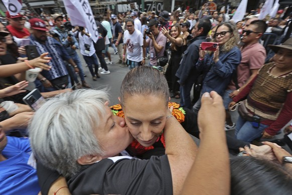 Former Mayor Claudia Sheinbaum is kissed by a supporter during a closing campaign rally for her presidential candidate bid to represent the ruling MORENA party, in Mexico City, Saturday, Aug. 26, 2023 ...