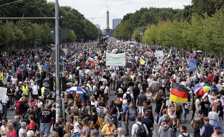 People attend a protest rally in Berlin, Germany, Saturday, Aug. 29, 2020 against new coronavirus restrictions in Germany. Police in Berlin have requested thousands of reinforcements from other parts  ...