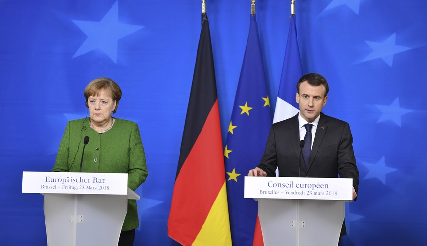 French President Emmanuel Macron, right, and German Chancellor Angela Merkel participate in a media conference at the conclusion of an EU summit in Brussels on Friday, March 23, 2018. (Geert Vanden Wi ...