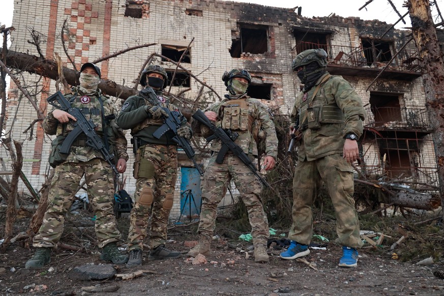 UKRAINE, DONETSK REGION - APRIL 10, 2023: Wagner Group soldiers are seen by a damaged building in the city of Artyomovsk Bakhmut. Artyomovsk is located in the Kiev-controlled area of the Donetsk Peopl ...