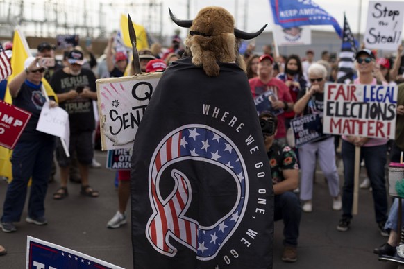 Nov 6, 2020 - Phoenix, Arizona, USA - A man wearing a cape referencing QAnon speaks as supporters of U.S. President Trump gather protest during a protest about the early results of the 2020 presidenti ...
