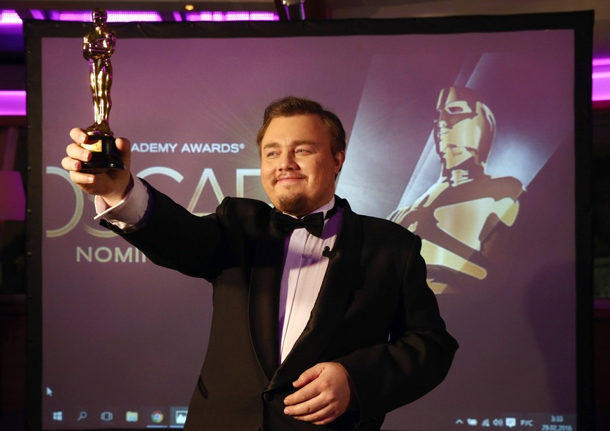 MOSCOW, RUSSIA. FEBRUARY 29, 2016. Roman Burtsev, Tech Support senior expert at 112 Emergency Service, a Russian doppelganger of American actor Leonardo DICAPRIO (Di Caprio), holds a statuette that he ...