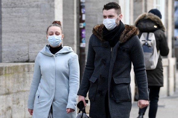 HAMBURG, GERMANY - MARCH 17: Pedestrians with face masks are seen after the Senate of Hamburg has released a decree to limit social life heavily on March 17, 2020 in Hamburg, Germany. Most of the shop ...