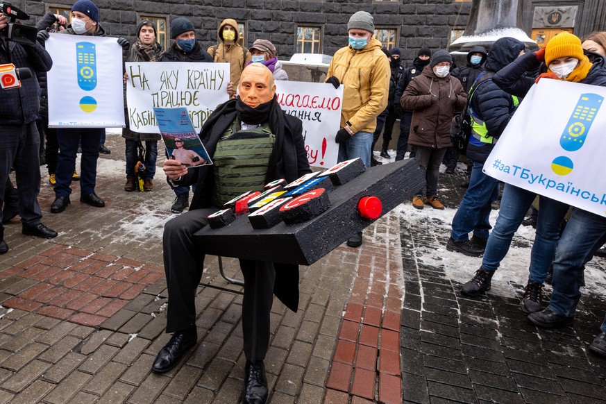 Ukrainian Protest In Kiev As Conflict Tension Stay High A protester with a Wladimir Putin mask protests against usage of Russian language in Ukrainian TV in front of the main governmental building on  ...