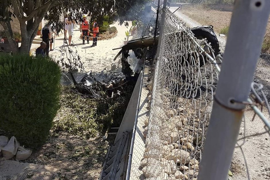 This photo provided by Incendios f.Baleares shows wreckage by a fence near Inca in Palma de Mallorca, Spain, Sunday Aug. 25, 2019. Authorities in Mallorca say at least 5 people have died in a collisio ...
