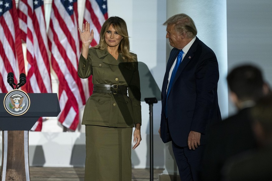 President Donald Trump joins first lady Melania Trump on stage after her speech to the 2020 Republican National Convention from the Rose Garden of the White House, Tuesday, Aug. 25, 2020, in Washingto ...