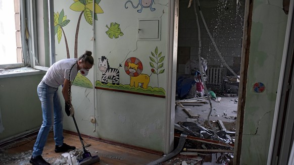 KYIV, UKRAINE - JULY 8, 2024 - A woman sweeps the rubble at the Ohmatdyt National Specialized Childrens Hospital attacked by Russias Kh-101 strategic cruise missile, Kyiv, capital of Ukraine. Two adul ...