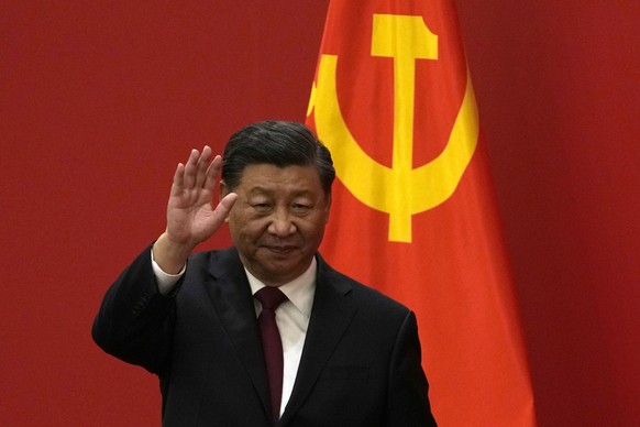FILE - Chinese President Xi Jinping waves at an event to introduce new members of the Politburo Standing Committee at the Great Hall of the People in Beijing, Sunday, Oct. 23, 2022. President Joe Bide ...