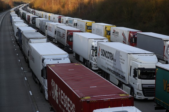 Trucks are parked up on the M20, part of Operation Stack in Ashford, Kent, England, Friday, Dec. 25, 2020. Thousands wait to resume their journey across The Channel after the borders with France reope ...