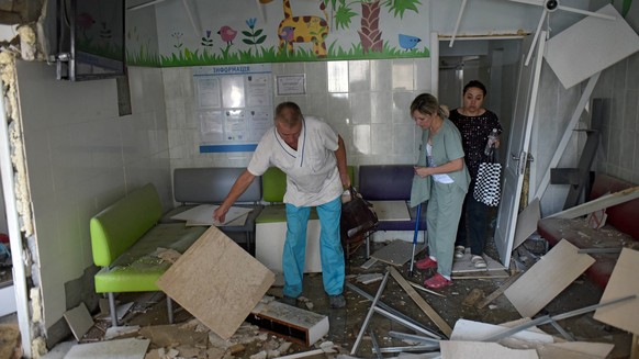 Children s Hospital Hit As Russian Strikes Kill Dozens - Kyiv A doctor accompanies an injured woman at the Ohmatdyt National Specialized Childrens Hospital attacked by Russias Kh-101 strategic cruise  ...