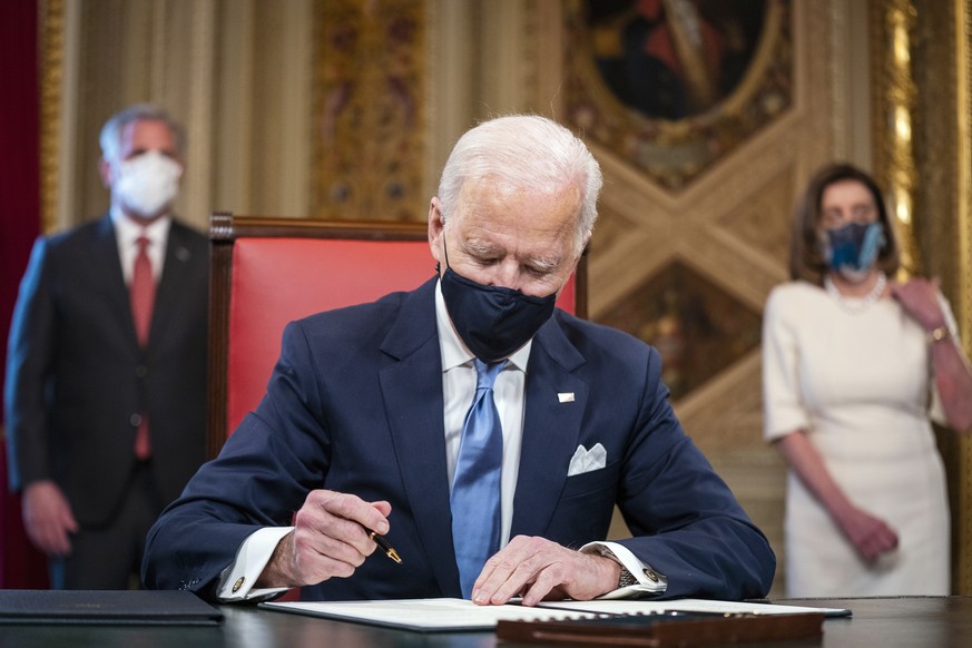 President Joe Biden signs three documents including an inauguration declaration, cabinet nominations and sub-cabinet nominations in the President&#039;s Room at the US Capitol after the inauguration c ...