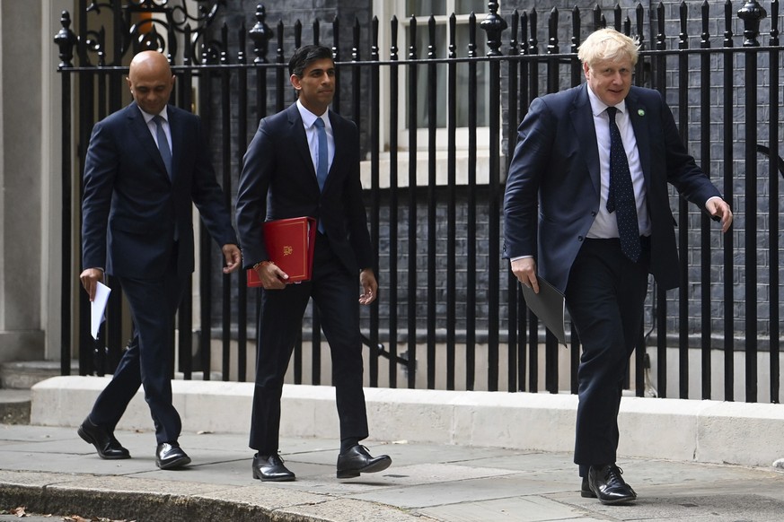 From left, British Health Secretary Sajid Javid, Chancellor of the Exchequer Rishi Sunak and Prime Minister Boris Johnson arrive at No 9 Downing Street for a media briefing on May 7, 2021. Two of Brit ...