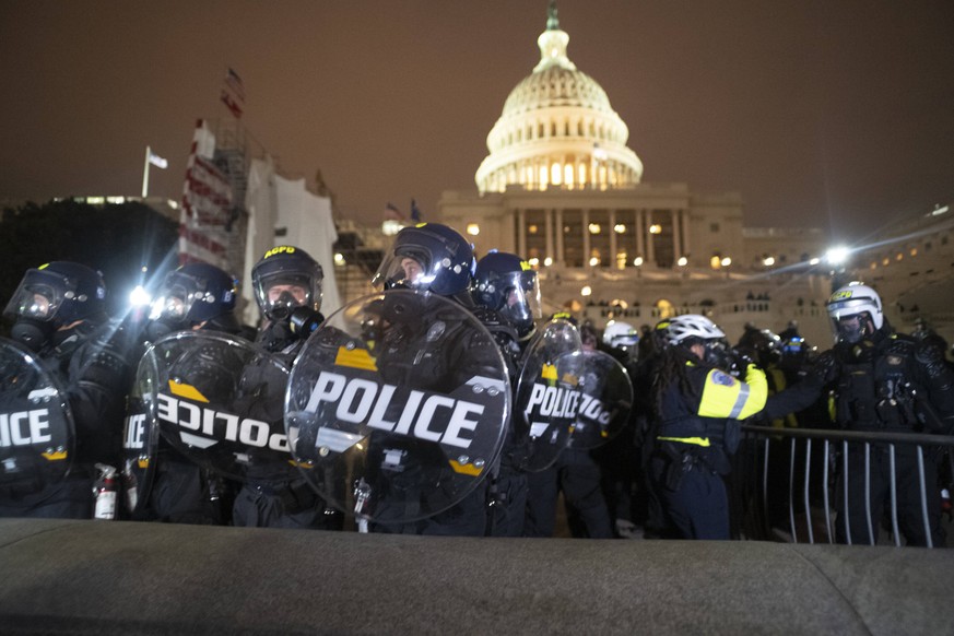 January 6, 2021: Washington, District of Columbia, USA: DC Metro Police as well as other Law Enforcement stand guard on the U.S. Capitol grounds after rioters clash against the U.S. Capitol Police and ...