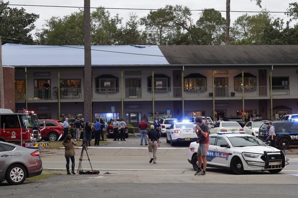 Police investigators work the scene of a shooting, Friday, Nov. 2, 2018, in Tallahassee, Fla. A shooter killed one person and critically wounded four others at a yoga studio in Florida's capital befor ...