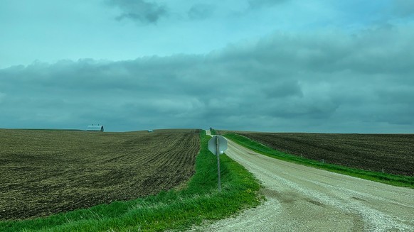 Driving through the countryside with farm land on the side of the road near Manilla, IL. Model Released Property Released xkwx House Plant agricultural agriculture american animals barn blue buildings ...