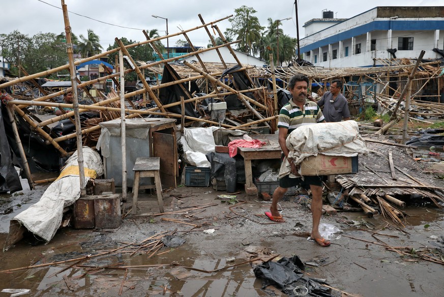 A man salvages his belongings from the rubble of a damaged shop after Cyclone Amphan made its landfall, in South 24 Parganas district in the eastern state of West Bengal, India, May 21, 2020. REUTERS/ ...